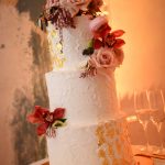 White wedding cake with gold foil accents