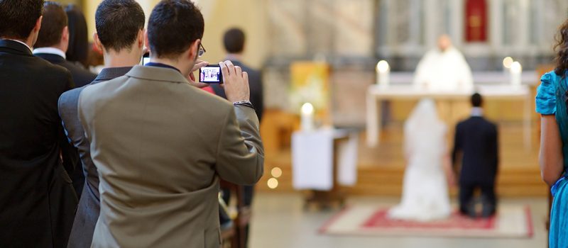 man taking photo at wedding ceremony